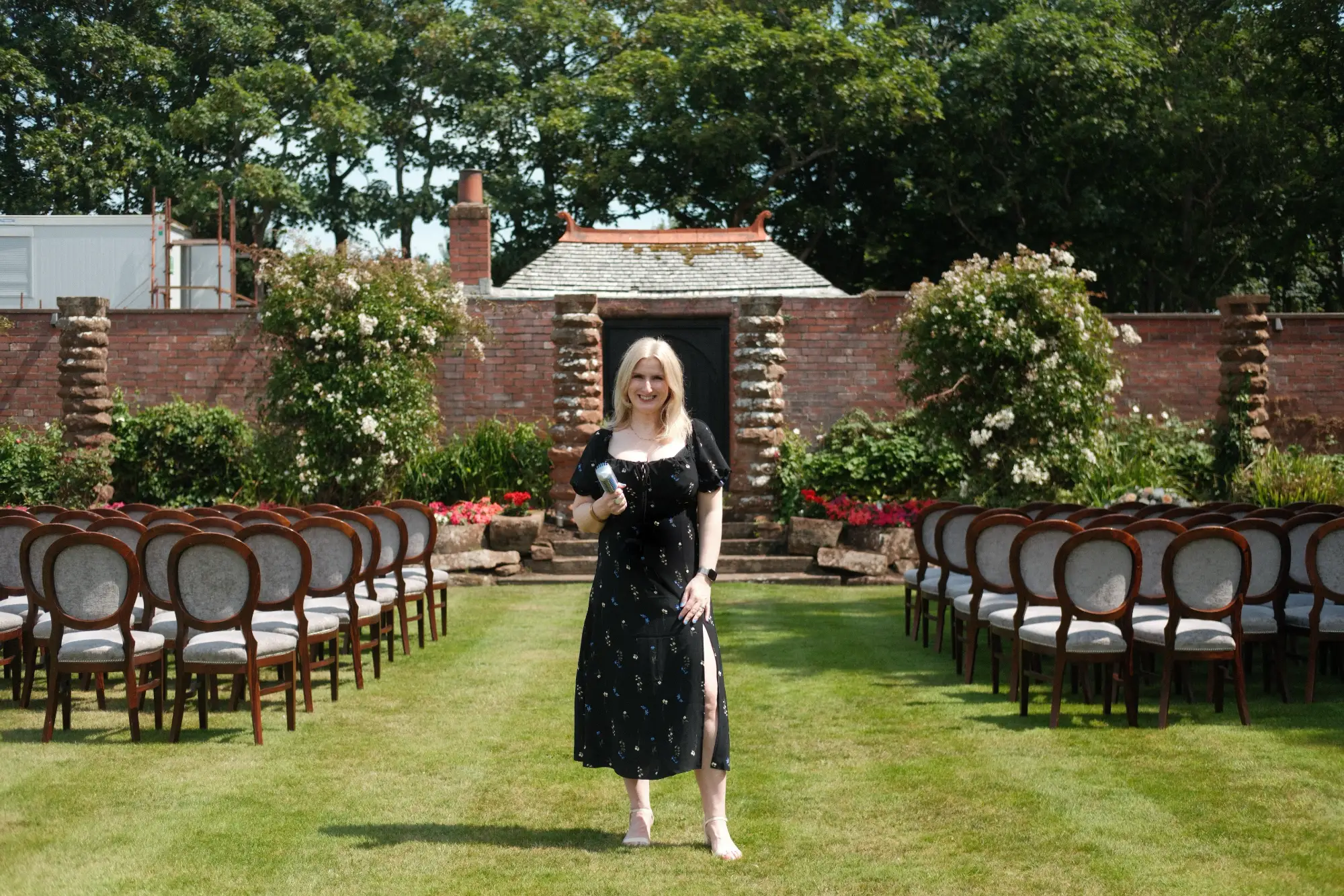 Award-winning female wedding singer Nicola Mason performing live music at an outdoor Scottish wedding ceremony